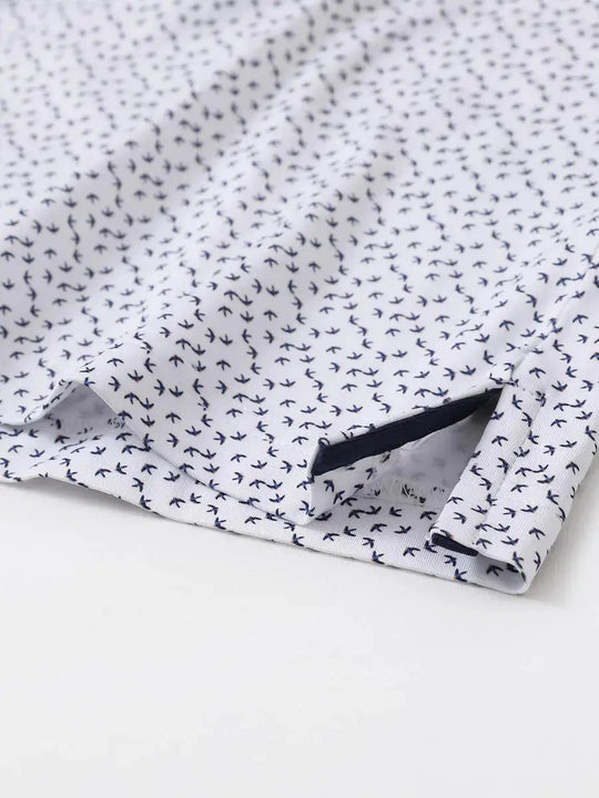 Hem slit detail of MAELREG Performance Jersey Print Polo in White Navy Swallow – comfort & movement