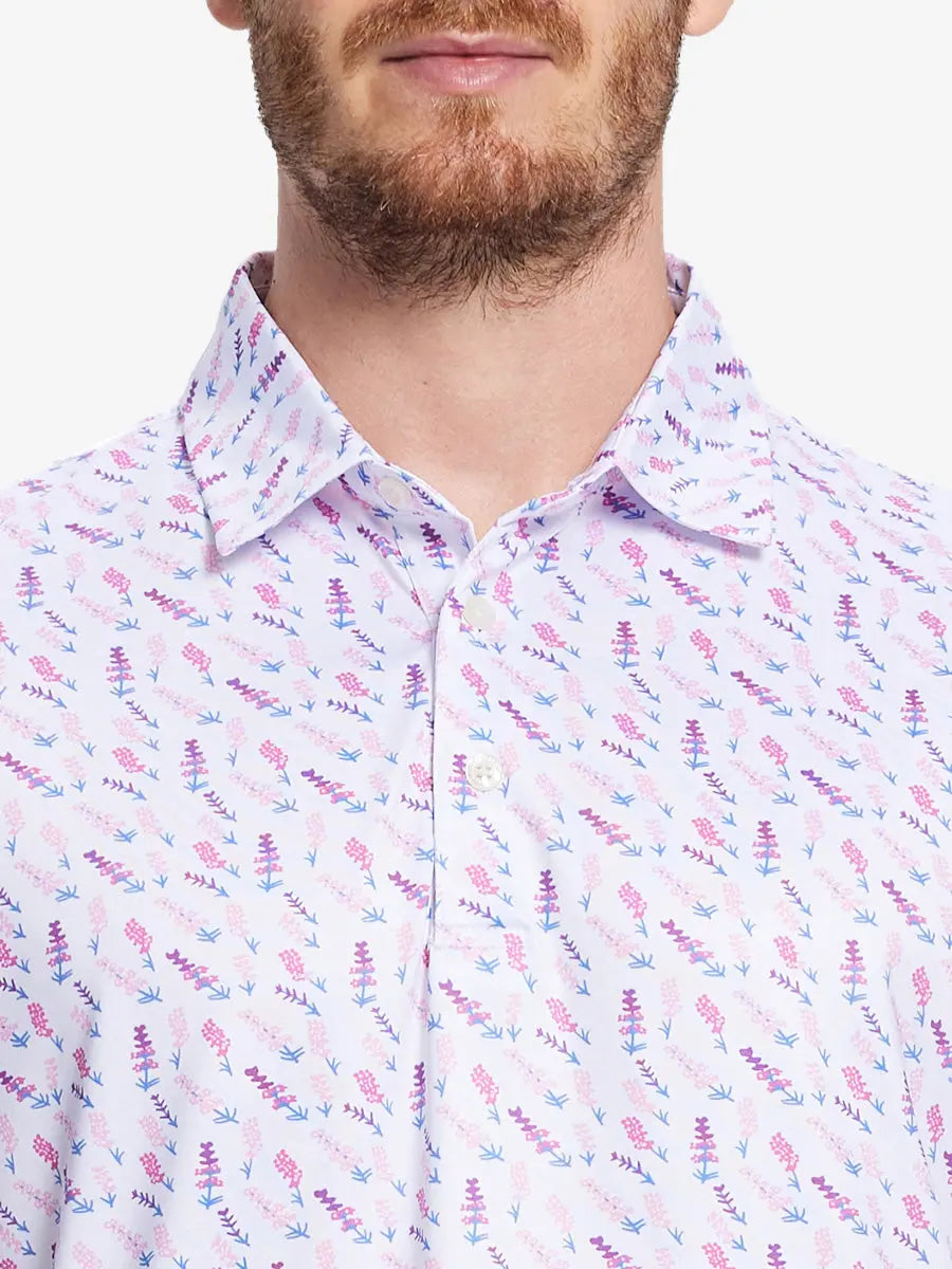 Model wears a WHITE MULBERRY LAVENDER  golf polo shirt, which emphasizes its cut and comfort when viewed from nose to chest