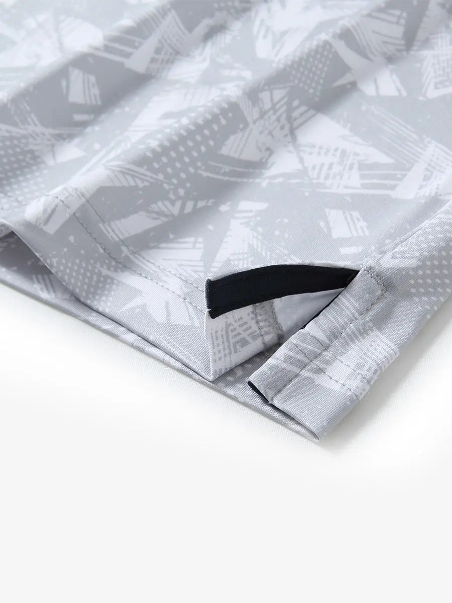Detail view of the grey abstract pattern polo shirt, emphasizing the smooth hem opening and modern style.
