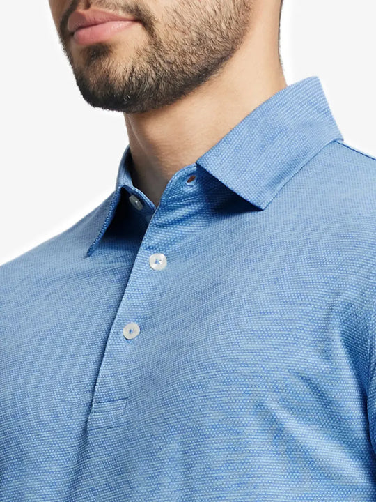 Model front close-up from nose to chest wearing Ventilated Heather Jacquard Polo in CLASSIC BLUE